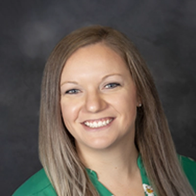 Chiropractor Katie Harris Smiling In Green Shirt
