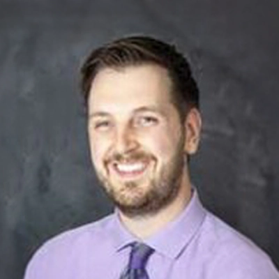 Chiropractor Patrick Hughes Smiling In Purple Shirt